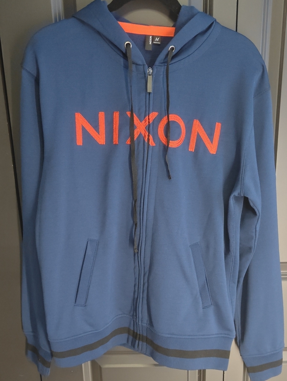 Nixon Men's Blue Zip-Up Hoodie with Orange Logo